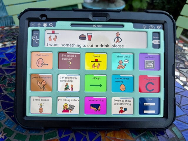 A light green keyguard on an iPad with TD Snap PODD page set displayed.