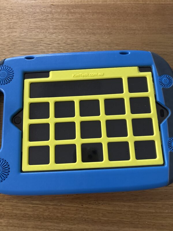 A yellow keyguard on on iPad in a GoNow case. The app displayed on the iPad is PODD 15.